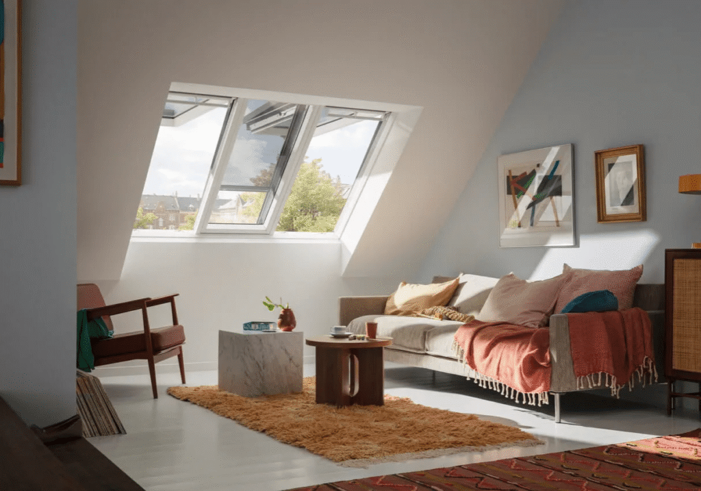 Inicio 12 Salón acogedor con sofá, alfombra cálida y ventanas Velux inclinadas en Segovia.